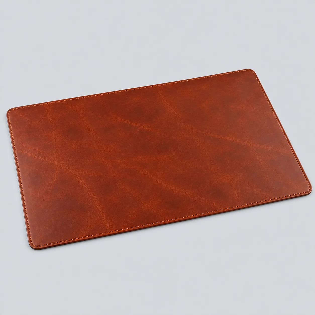 Leather desk pad product direction on a neutral studio background