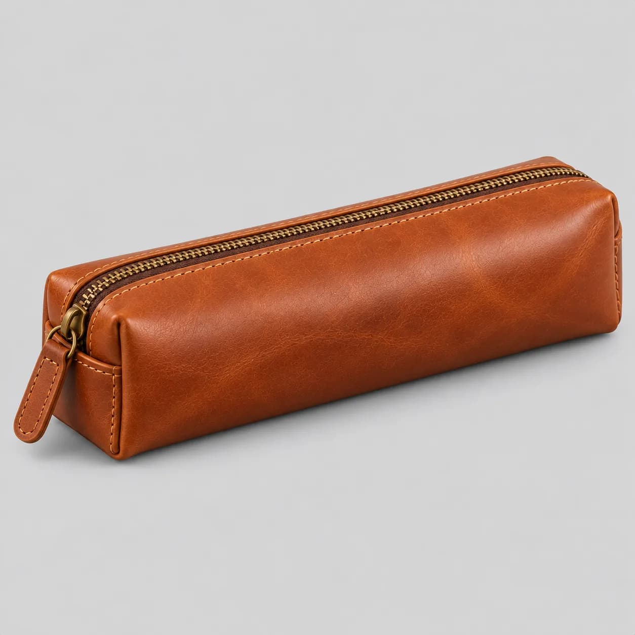 Leather pen and pencil case product direction on a neutral studio background