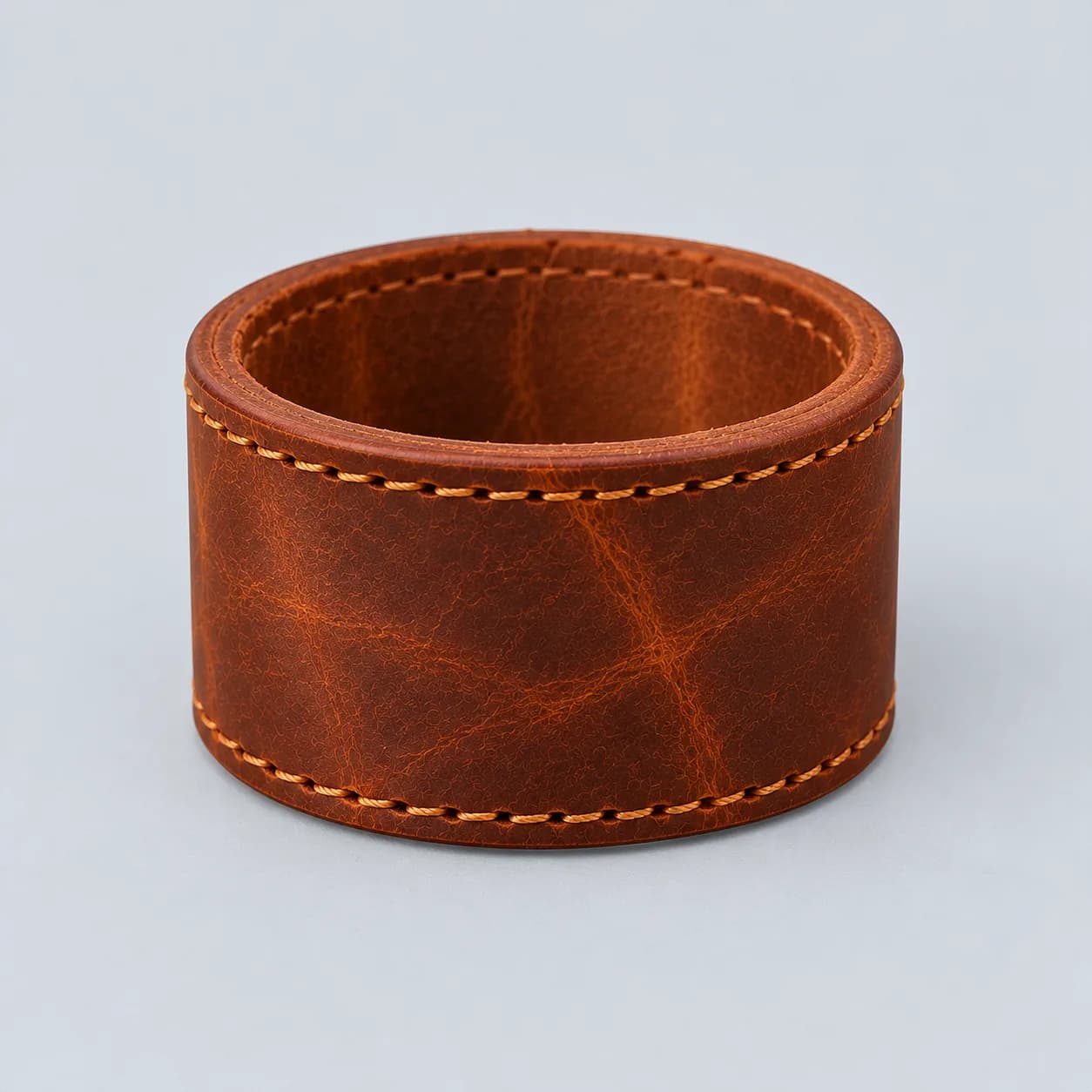 Leather napkin ring product direction on a neutral studio background