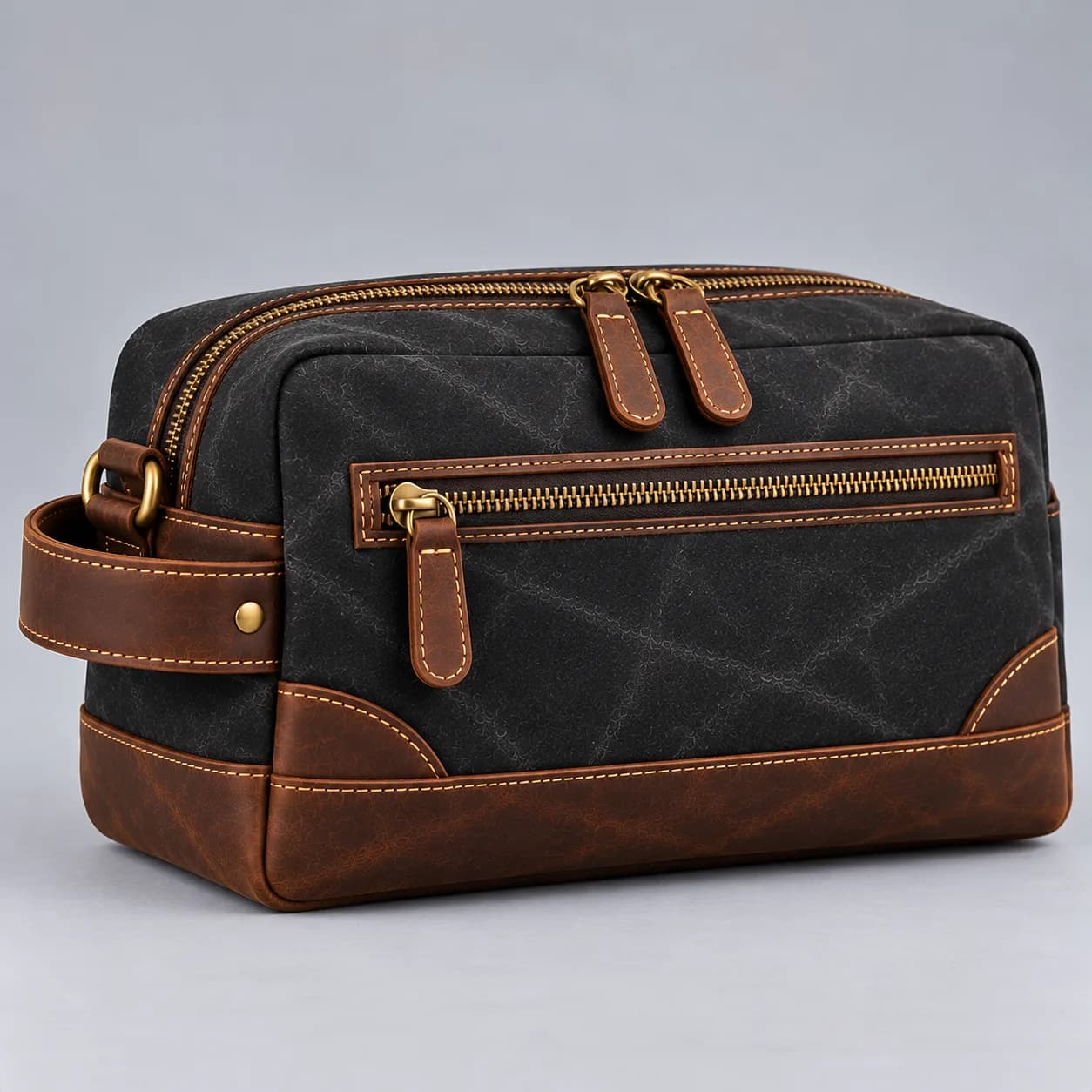 Waxed canvas and leather toiletry bag product direction on a neutral studio background
