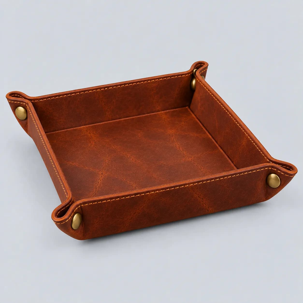Leather valet tray product direction on a neutral studio background