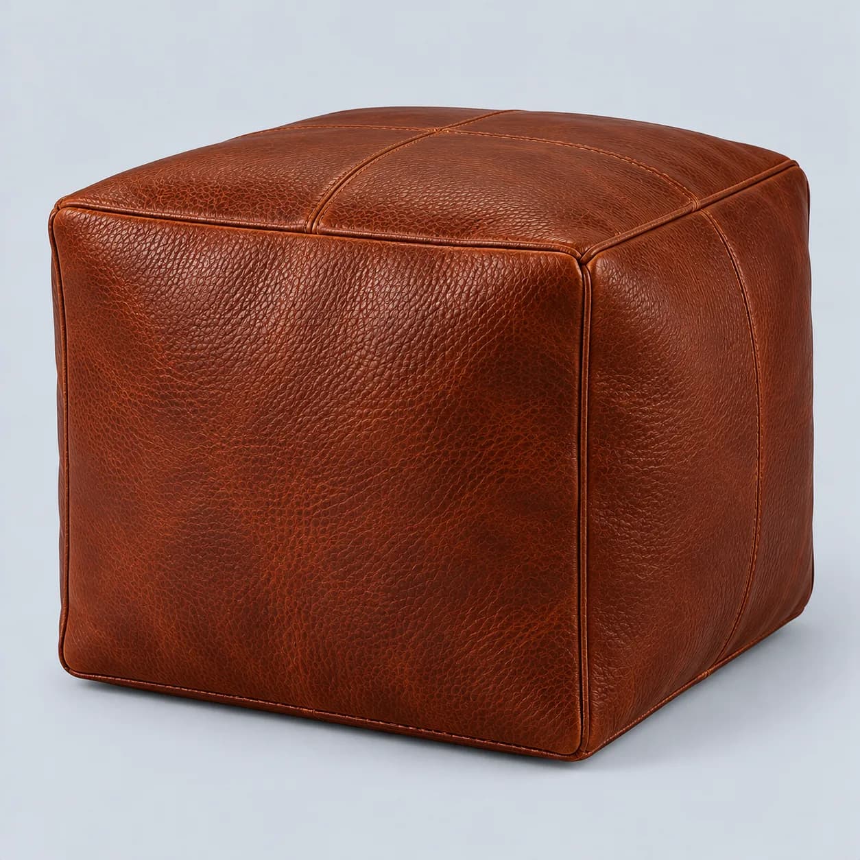 Leather pouf product direction on a neutral studio background