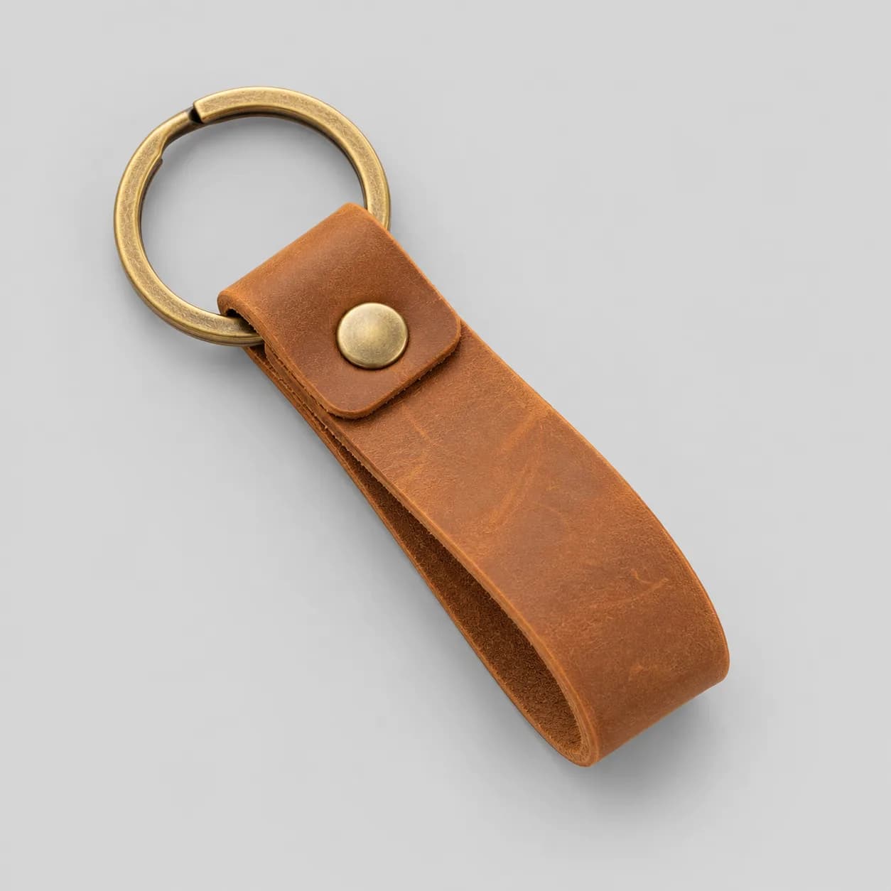 Leather key ring and key fob product direction on a neutral studio background