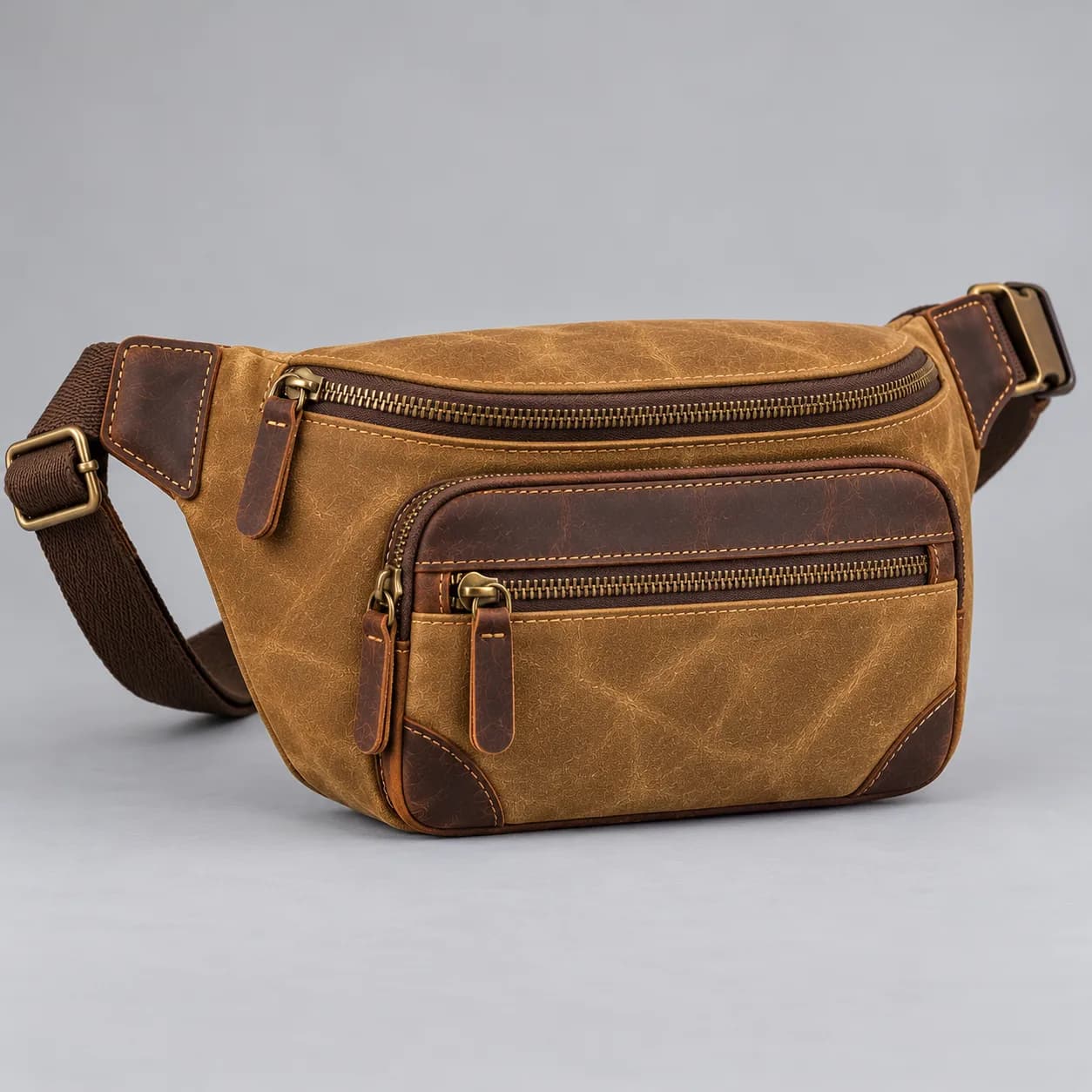 Waxed canvas and leather fanny pack product direction on a neutral studio background
