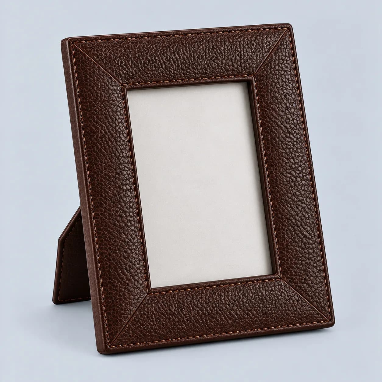 Leather photo frame product direction on a neutral studio background
