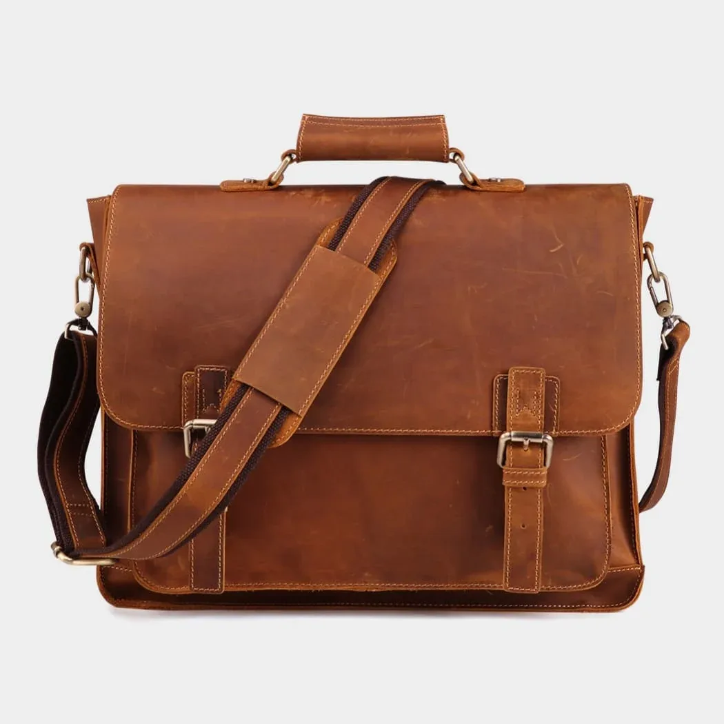 Tan leather briefcase with flap, twin buckles and shoulder strap